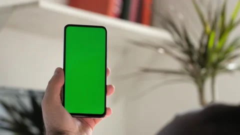 Point of View of business man using smartphone viewing green screen on mobile ph Stock Footage 154722345