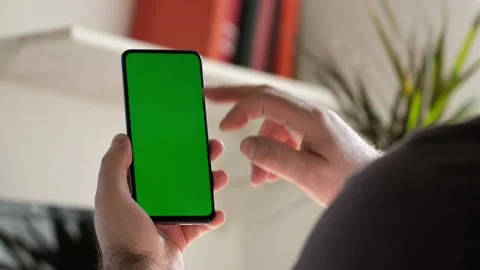 Point of View of business man using smartphone viewing green screen on mobile ph Stock Footage 154722397