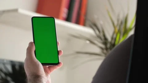 Point of View of business man using smartphone viewing green screen on mobile ph Stock Footage 154722493