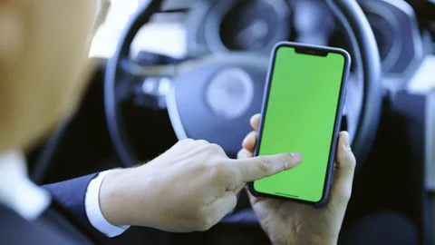 Point of View Camera of Man Using Smartphone in Vertical Mode with Green Mock-up Stock Footage 194755959