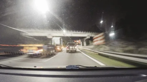 Point Of View from car dashboard driving in traffic at night Stock Footage 92565634