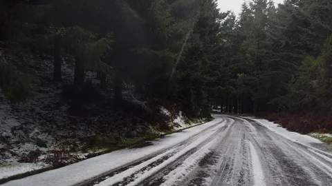 Point of view of a car driver progressing through a winter road in Poiso Stock Footage 121629972