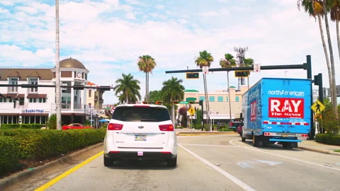 Point of view car driving in downtown Naples, Florida with retail stores Stock Footage 218272602