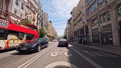Point of view car driving on Gran Via street of Madrid city center on sunny day Vidéo 254805425