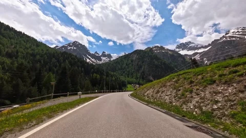 Point of view from a car driving on a mountain road with stunning Swiss Alps Stock Footage 301547496