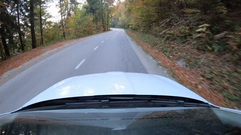 Point of view: Car driving on a road in the countryside in fall  at sunset Stock Footage 97122829