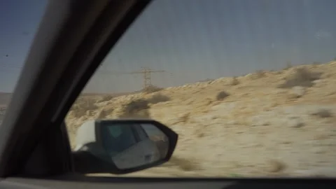 Point of view from car or vehicle window while driving on desert road in summer Stock Footage 313904366