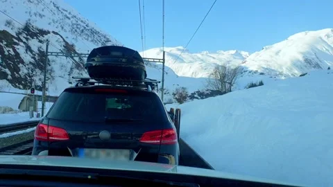 Point of View from Car Shuttle Train Passing Snow-Covered Swiss Alps Stock Footage 345001079