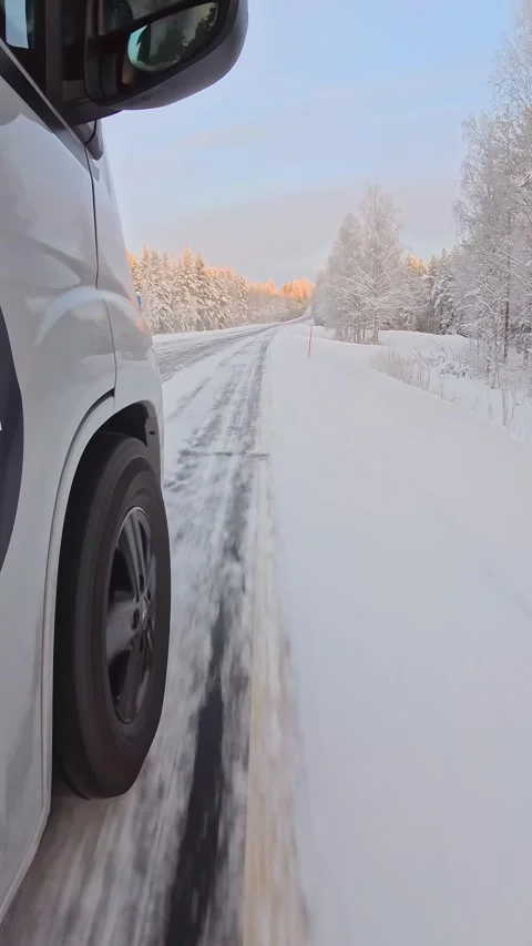 Point of view close up front winter tire rolling on icy snow covered road t.. Stock Footage 328466773