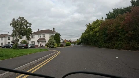Point of view cycling through housing estate over ramp. Green trees. Stock Footage 232960479