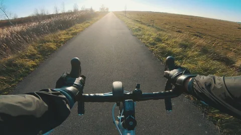 Point of view of cyclist who rides racing bicycle and holds on to handlebar Stock Footage 98763539
