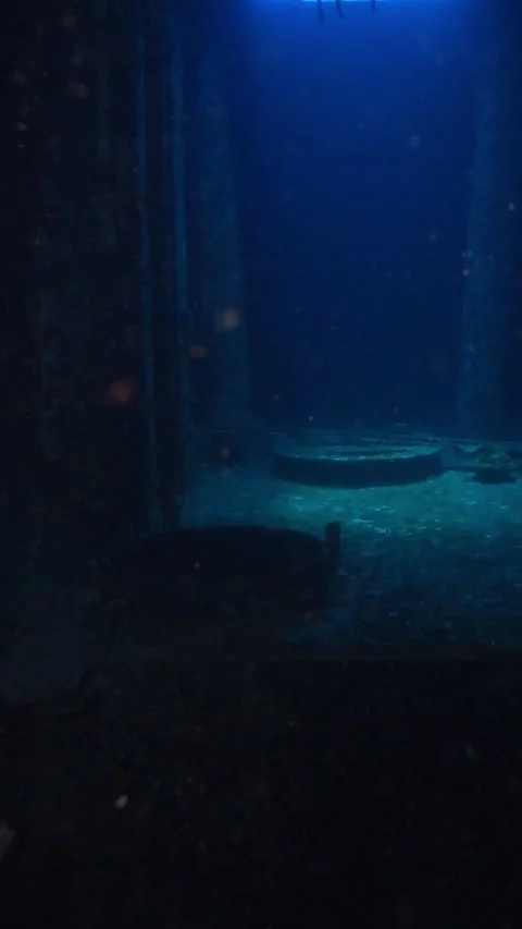 Point of view of a diver moving through the dark and rusty corridors of a sunken Stock Footage 332000855