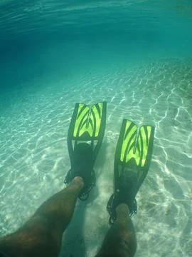 Point of View of Diver Wearing Yellow Fins in Clear Turquoise Ocean Water Stock Photos