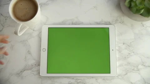 Point of view drinking coffee with green screen tablet on granite table, 4k Stock Footage 112227884