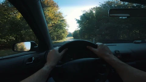 Point of view for driver who drives car on country roads while the sun shines Video stock 98075621
