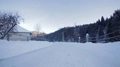 Point of view from drive's side, vehicle driving on snowy mountain road. 動画素材 126246605