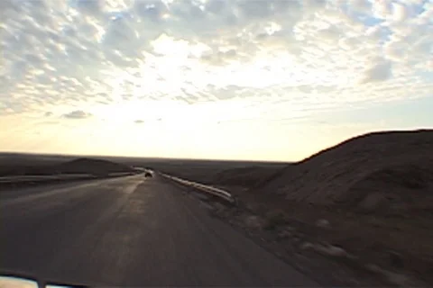 Point of view driving across flat, barren desert leaving Kirkuk. Stock Footage 86753665