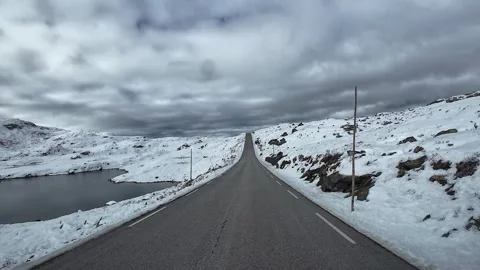 Point of view driving along a scenic mountain pass in winter with snow cove.. Stock Footage 327667880