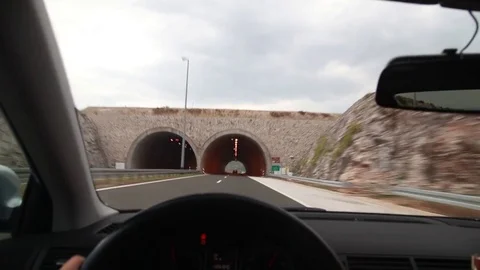 Point of view driving a car through a tunnel and a mountain road Stock Footage 71534035