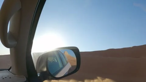 Point of view driving SUV up sandy desert dune on sunny day Video stock 329232576