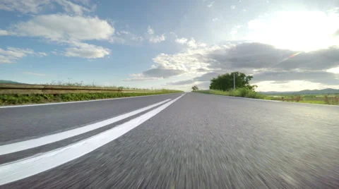 Point-of-view driving through rural road with with sunset sun burst pov Stock Footage 64412978