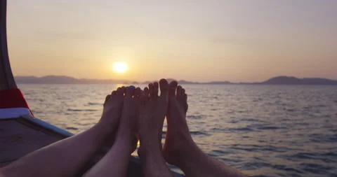 Point Of View of feet: Adventurous couple on journey traveling on long tail boat Stock Footage 201094460