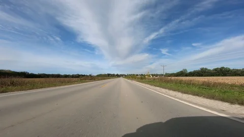 Point of view footage while driving down a paved road in rural Iowa; Stock Footage