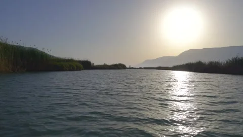 Point of view from the front of a moving boat gliding - Waterway Background Stock Footage 340010029