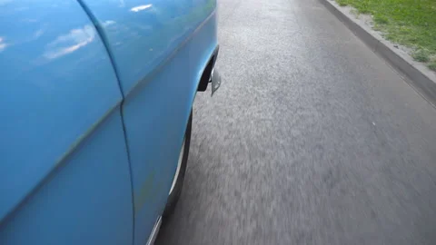 Point of view to front right tire of retro car. Wheel of old automobile riding Stock Footage 92354594