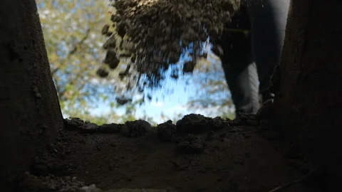 Point of view from grave into which soil is sprinkled from  shovel 스톡 동영상 131012279