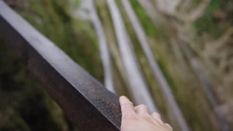 Point Of View Of Hand Grasping Railing Over Forest Gorge Stock Footage 310229451