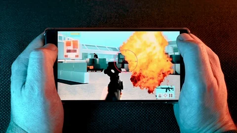 Point of view of holding a smart phone and playing a video game Stock Footage 101078922