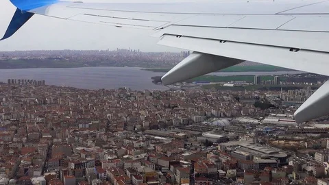 The point of view from inside the aircraft. Roofs of houses below. Stock Footage 87913247