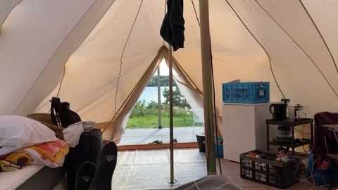 Point of view from inside a tent, looking out onto a campsite Stock Footage 318175172