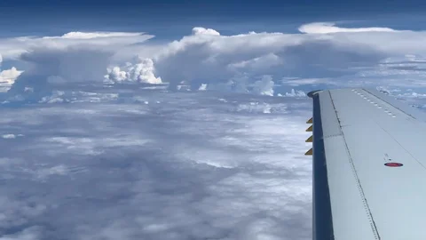 Point of view looking out a jet airplane window at amazing clouds. Stock-Footage 104581601