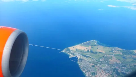 Point of view looking through easyJet plane window flying over Oresund Bridge Stock Footage 244742522