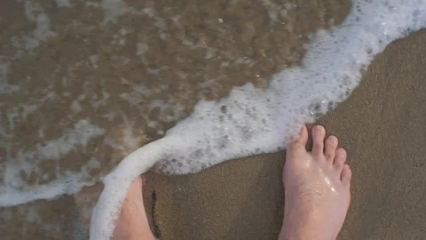 Point of view of man bare foot on sandy beach into sea wave Stock Footage 100068404