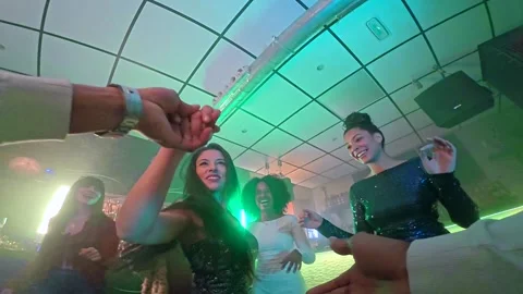 Point of view of man dancing with women in nightclub Stockbeeldmateriaal 328198397