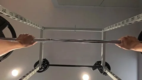 Point of view of a man doing a bench press using a barbell in the gym. Видео 324240779