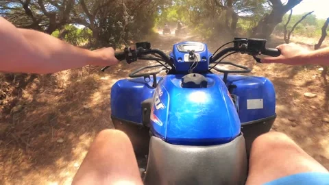 Point of view man driving ATV on off-road on a sunny day Stock Footage 158799435