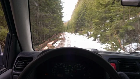 Point of view of a man driving a car on a snowy mountain off-road Stock Footage 98238980