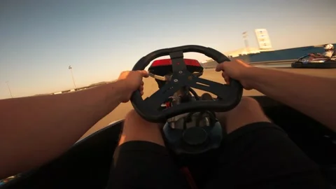 Point of view man driving a kart outdoor at sunset Video stock 158250596
