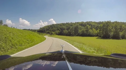 Point of view man driving a Rolls Royce Phantom on a country road vineyard Italy Stock Footage 98238821