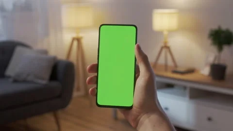 Point of View of Man Holding Chroma Key Green Screen Smartphone Watching Content Видео 172013253