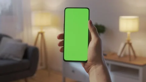 Point of View of Man Holding Chroma Key Green Screen Smartphone Watching Content Video stock 172014243