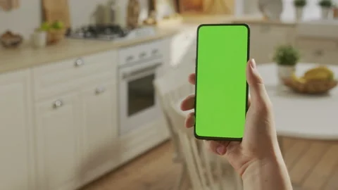 Point of View of Man at Kitchen Room Sitting on a Chair Using Phone With Green Stock Footage 205575351