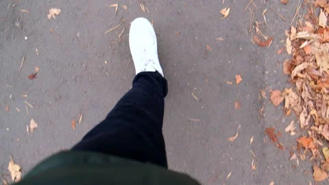 Point of view man legs in white sneakers walking by street Stock Footage 165773902