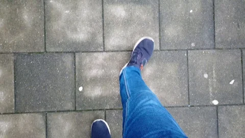 Point of View - Man looking down at pavement while walking Stock Footage 124854809