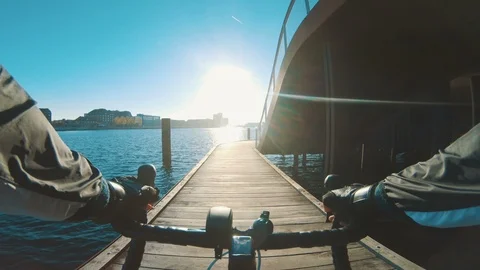 Point of view of man riding bicycle next to harbour in the city Stock Footage 98753762