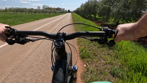 Point of view. Man riding bicycle surrounded by green nature Stock Footage 188902360